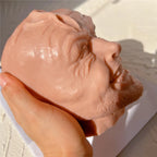 Expressive head casting held in one hand
