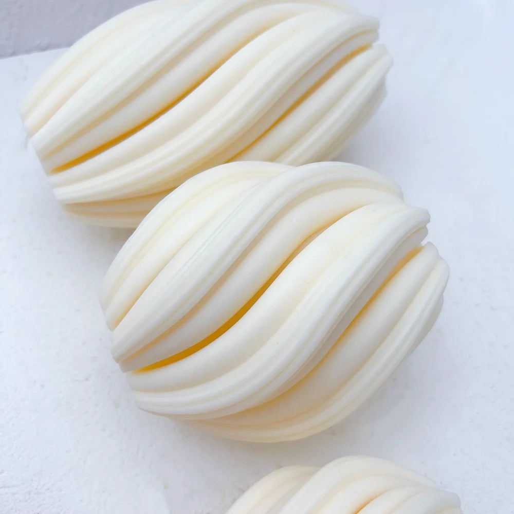 Close view of curved ribs on oval candle castings lying on their sides