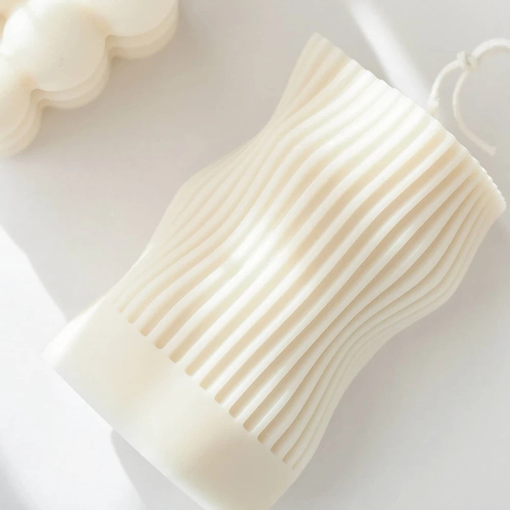 Ribbed pillar candle laid down to show its wavy profile