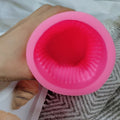Pink ribbed pillar silicone mold showing the interior cavity