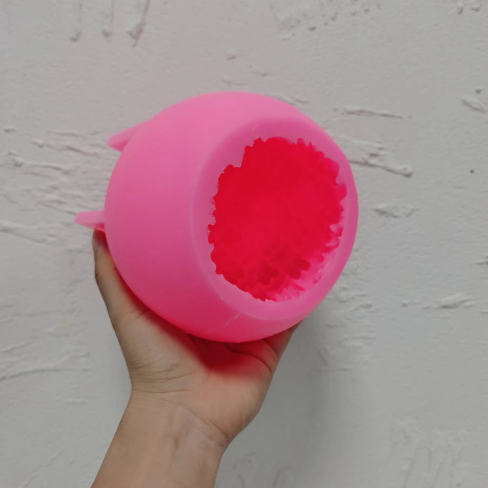 Pink silicone ball mold showing the textured cavity opening