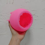 Pink silicone ball mold showing the textured cavity opening