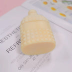 Angled bottle casting showing stud bands and flat base