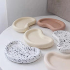Several shallow organic tray castings with curved rims