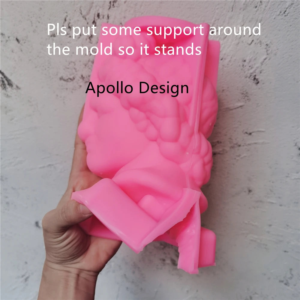 Pink Apollo head silicone mold held in one hand