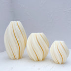 Tall medium and small oval candles with curved diagonal ribs