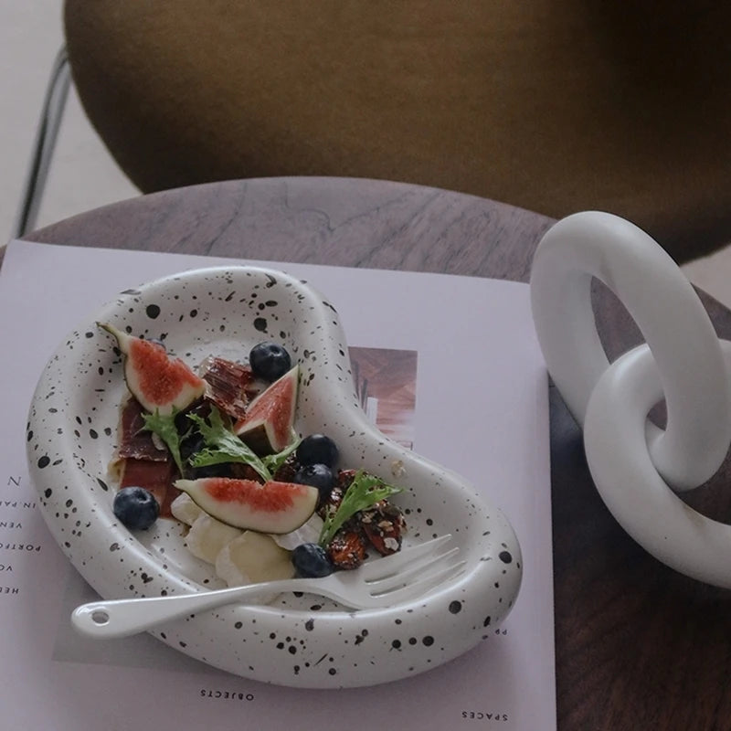 Speckled kidney tray staged with food and a utensil