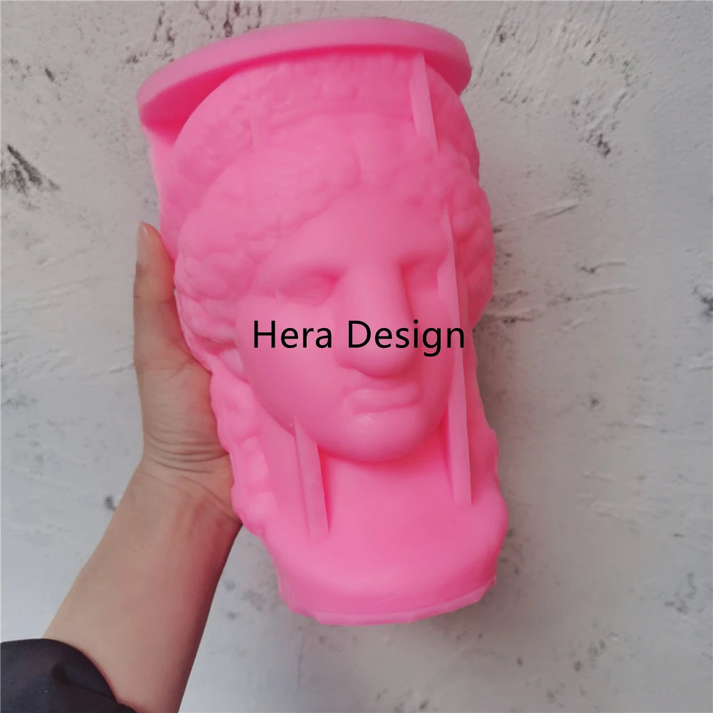 Pink Hera head silicone mold held in one hand