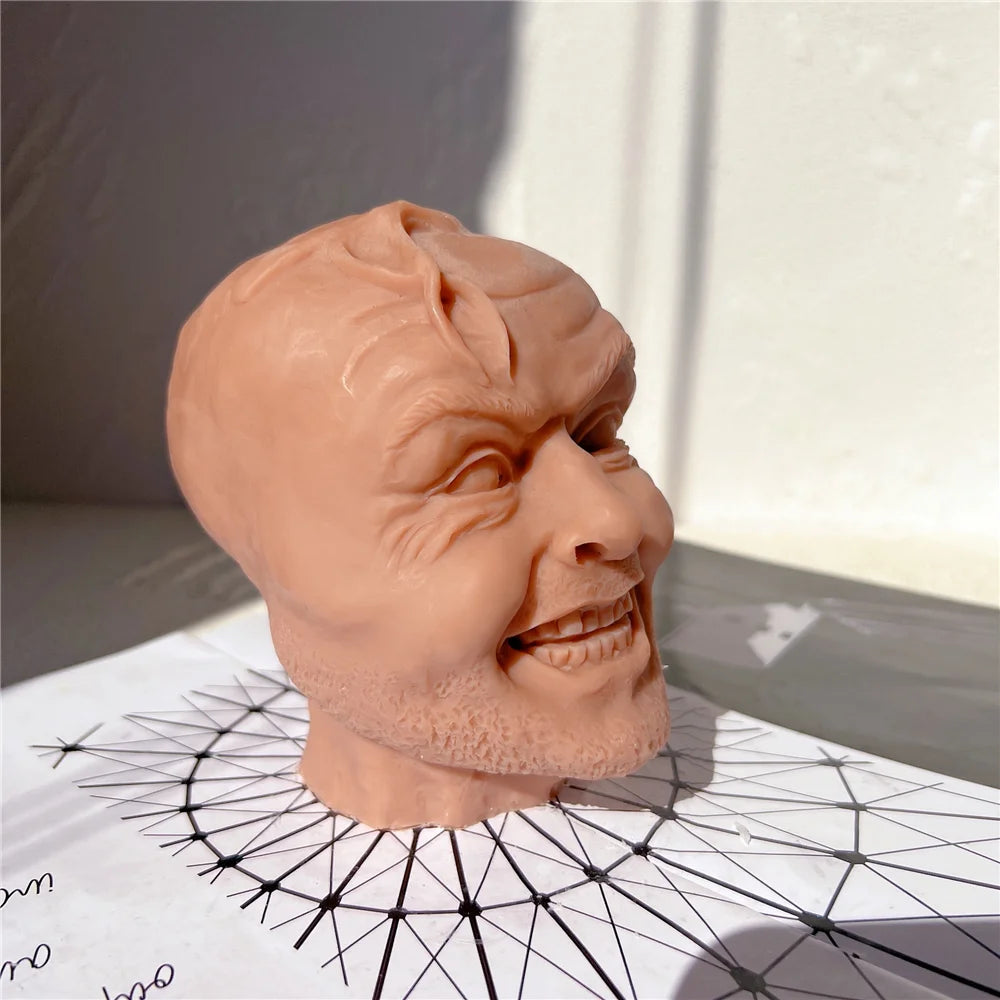 Right-side view of an expressive grinning head casting