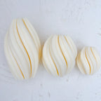 Angled view of matching twisted oval forms in three sizes