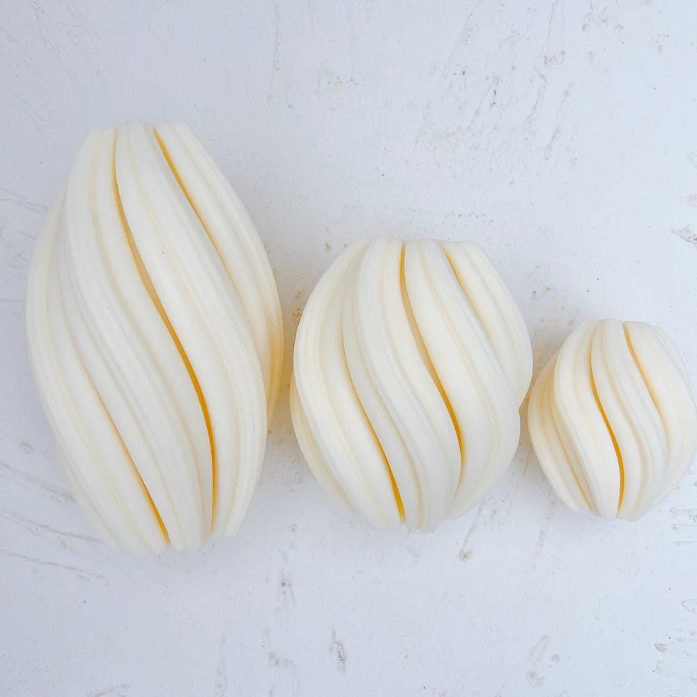 Angled view of matching twisted oval forms in three sizes