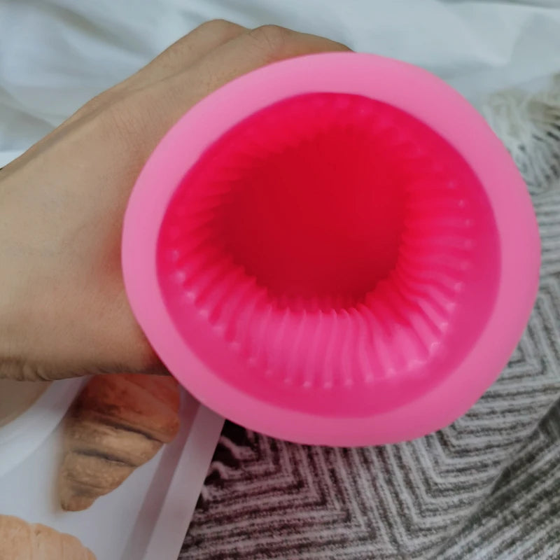 Pink silicone ribbed pillar mold viewed through its opening