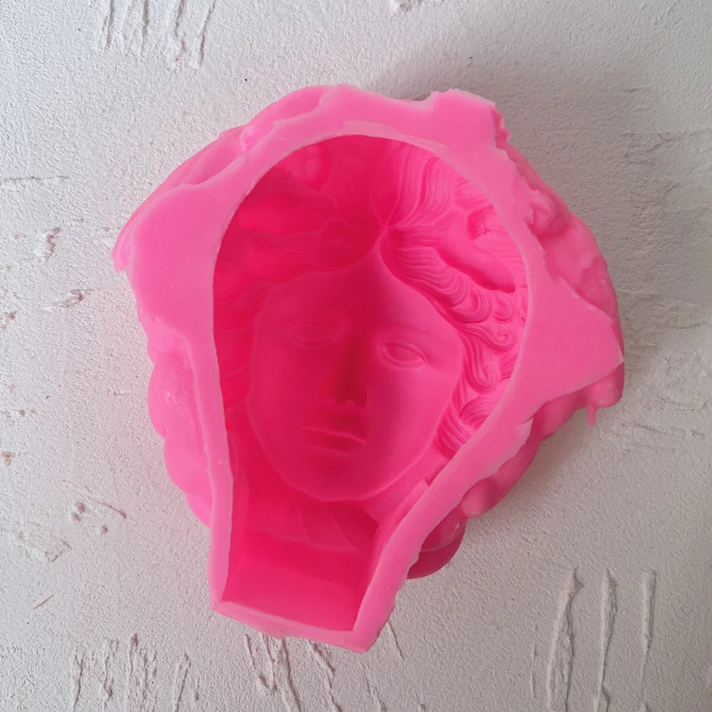 Pink silicone Medusa face mold with coiled hair cavity