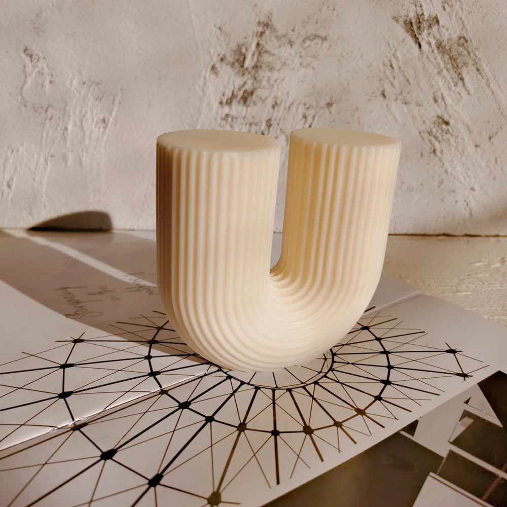 Rounded ribbed U candle casting standing upright