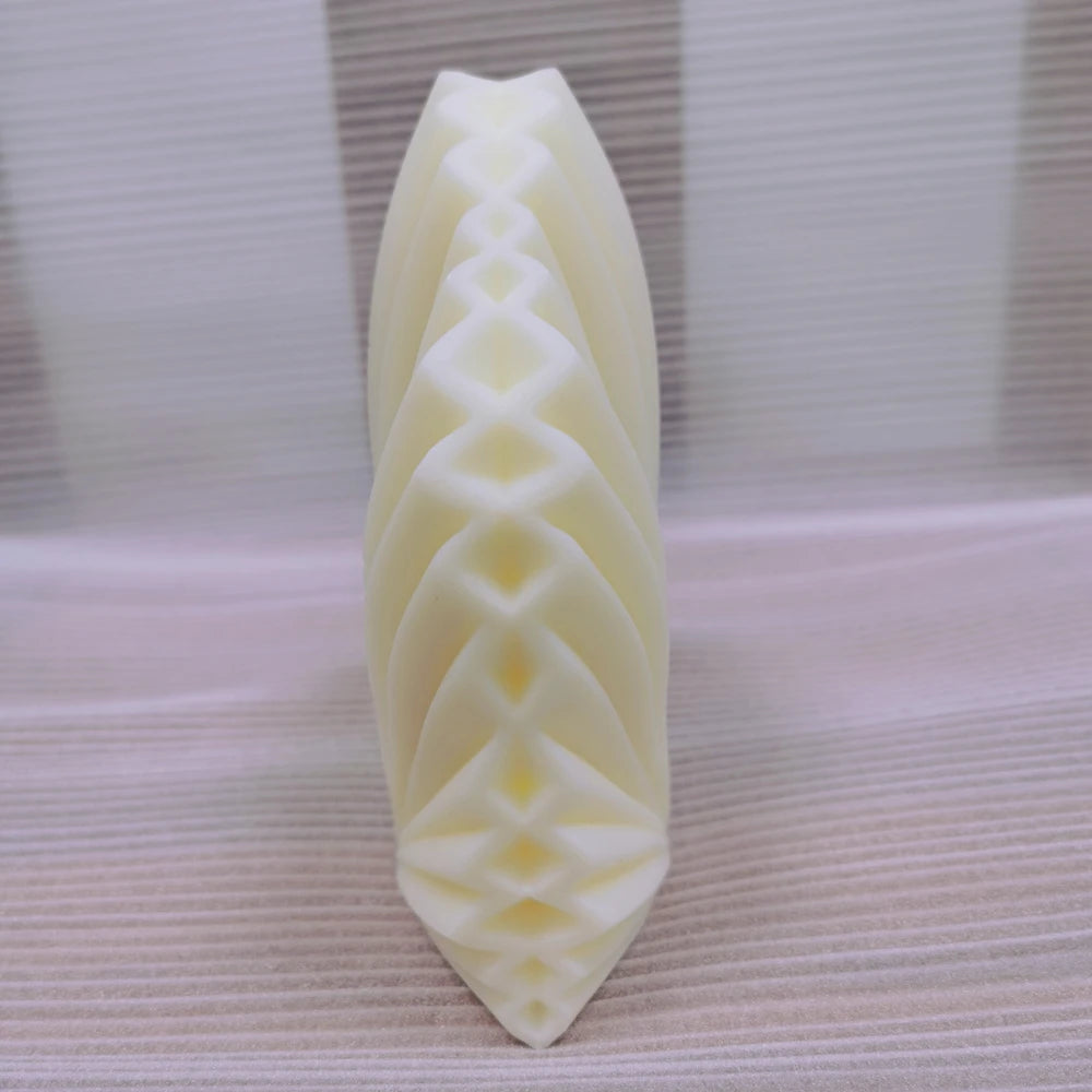 Side view of the same geometric leaf candle showing interlaced raised folds