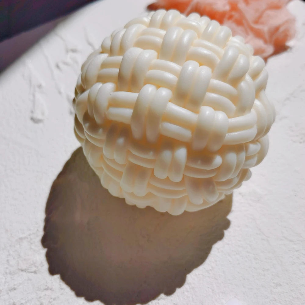 Cream ball candle with thick interlaced basket-weave bands