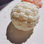 Cream ball candle with thick interlaced basket-weave bands