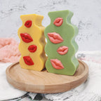 Green and yellow lips relief plaques on a tray