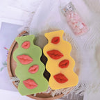 Green and yellow wavy lip plaques displayed together