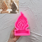 Pink silicone mold with detailed curling flame pattern and rectangular base cavity
