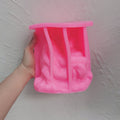 Pink Pietà sculpture silicone mold held in one hand