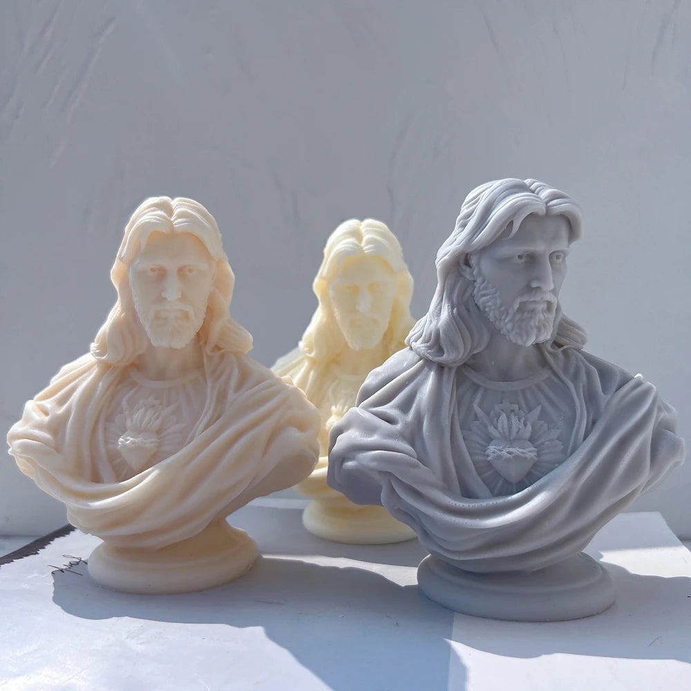 Three Sacred Heart Jesus bust candle castings on rounded pedestals