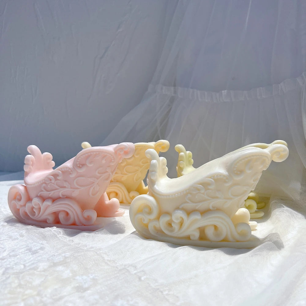 Pastel ornate Christmas sleigh candle castings with curved runners
