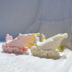 Pastel ornate Christmas sleigh candle castings with curved runners