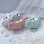 Pink, cream and mint whale castings viewed from the side