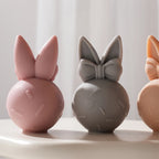 Plain ear backs beside bow-decorated bunny fronts