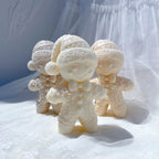 Cream winter hat gingerbread candles in a decorative arrangement