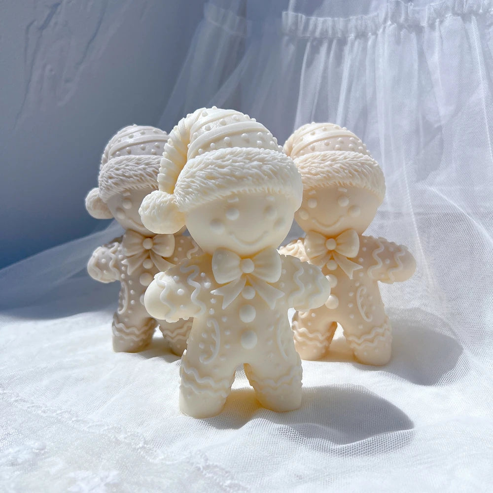 Cream winter hat gingerbread candles in a decorative arrangement