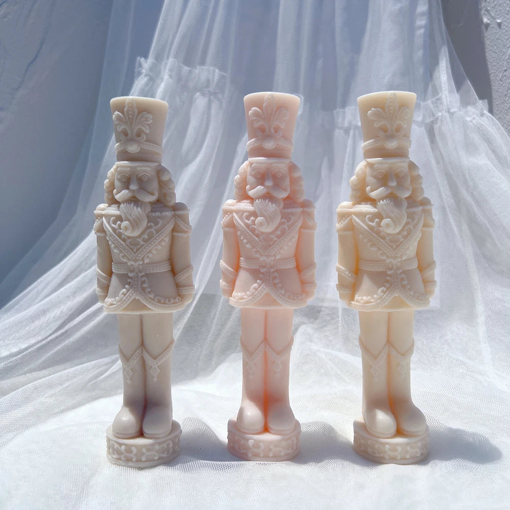 Three slim standing nutcracker castings with tall hats and long boots