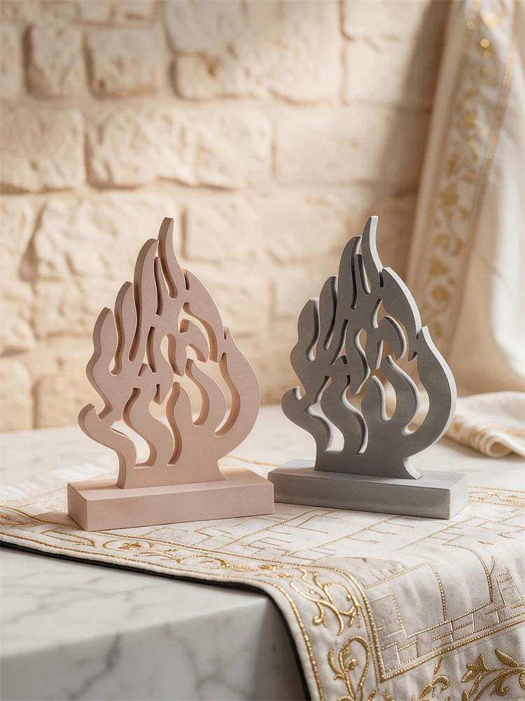 Two openwork flame plaques displayed on rectangular bases