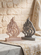 Two openwork flame plaques displayed on rectangular bases