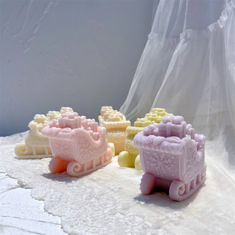 Side and rear views of decorated sleigh candles with raised gift details