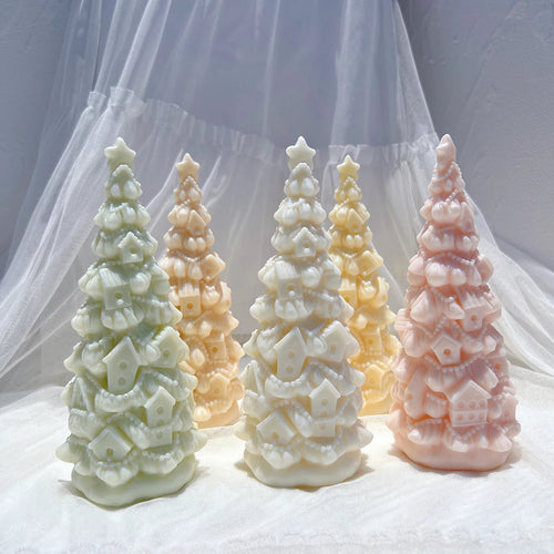 Pastel birdhouse tree candles grouped on lace
