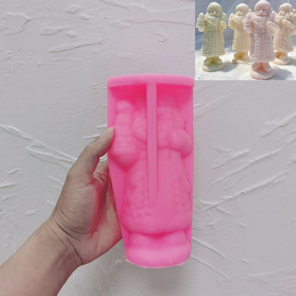 Pink long-coat Santa silicone candle mold held in one hand