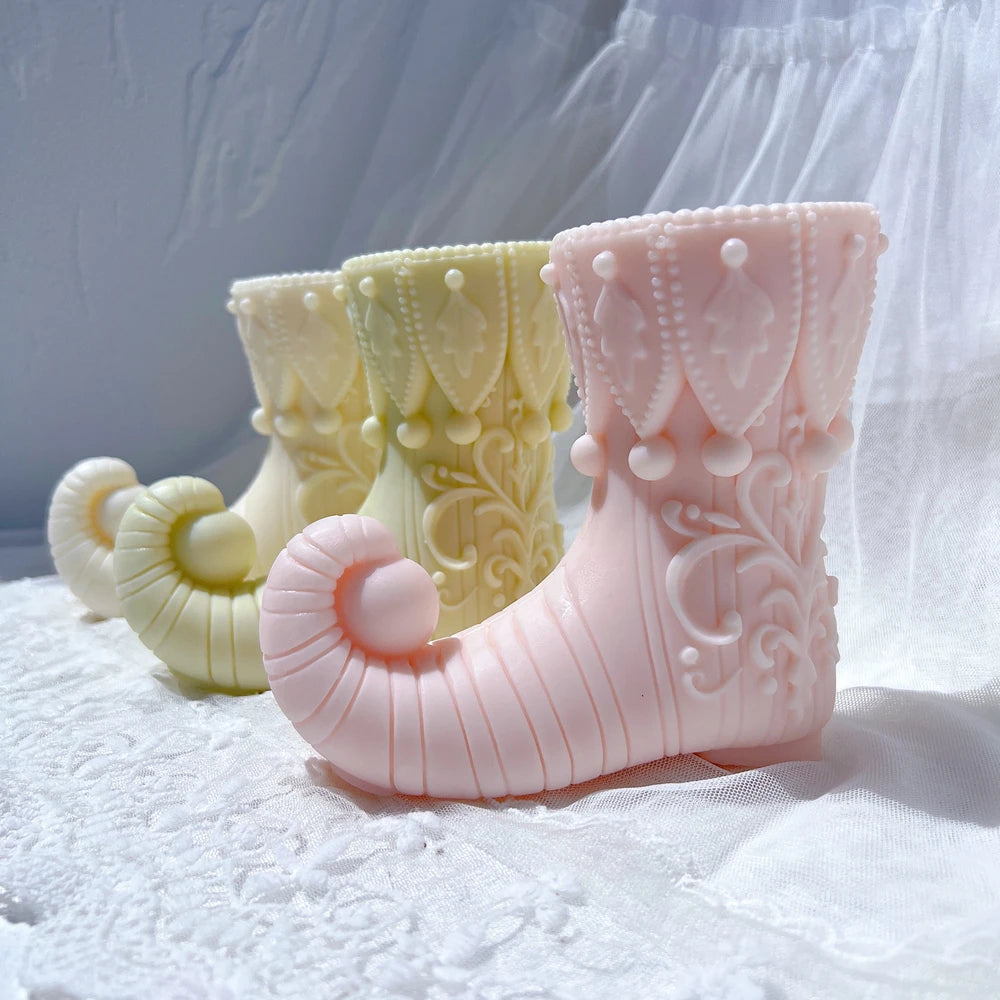 Pink and yellow elf boot castings with curled toes