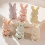 Standing rabbit candle figures seen from front and side