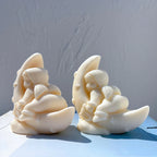 Side views of seated angels cradled by crescent moons