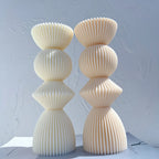 Two stacked ribbed geometric candle samples showing flared tops and rounded centers