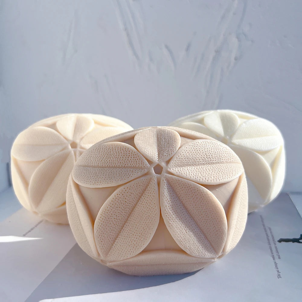 Rounded cube candle castings with raised leaf-petal rosettes