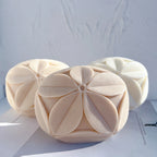 Rounded cube candle castings with raised leaf-petal rosettes