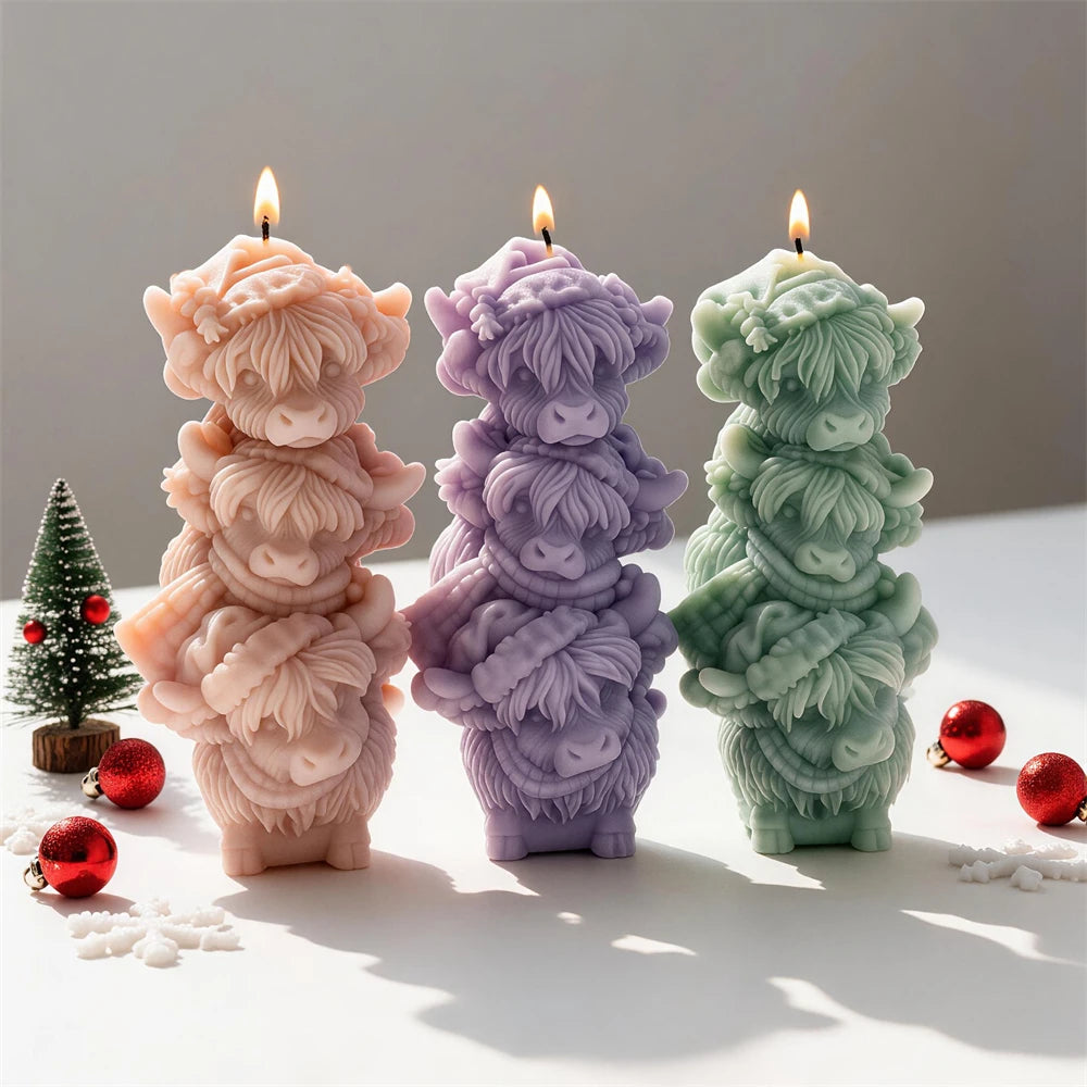 Pink purple and green candles formed from three stacked Highland cow heads