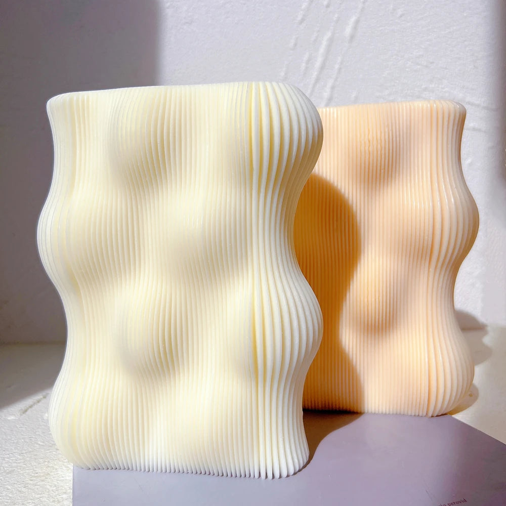 Ivory and peach rectangular candles with rounded wave contours