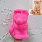 Pink wolf cub silicone candle mold held in one hand