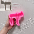 Pink silicone mold showing cutouts and contours of the Hebrew Chai letters