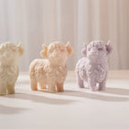 Cream, peach and lilac Highland cow castings on a display stand
