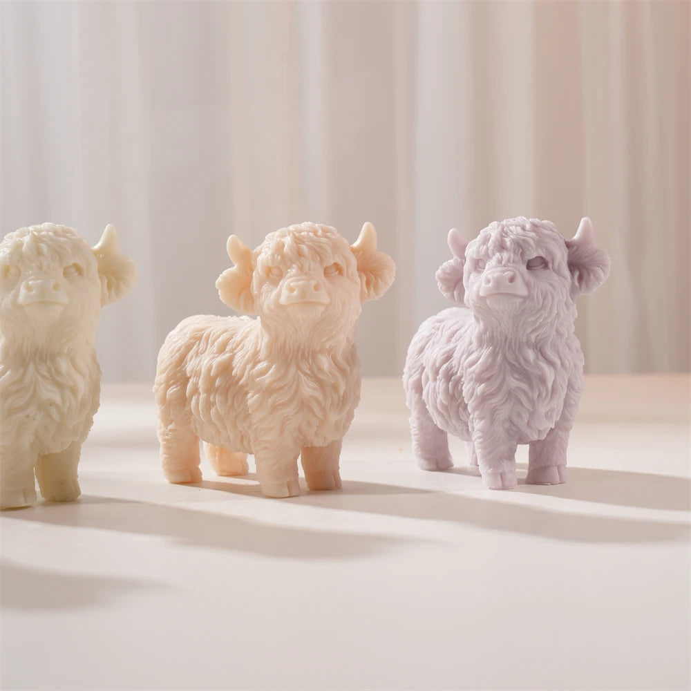 Cream, peach and lilac Highland cow castings on a display stand